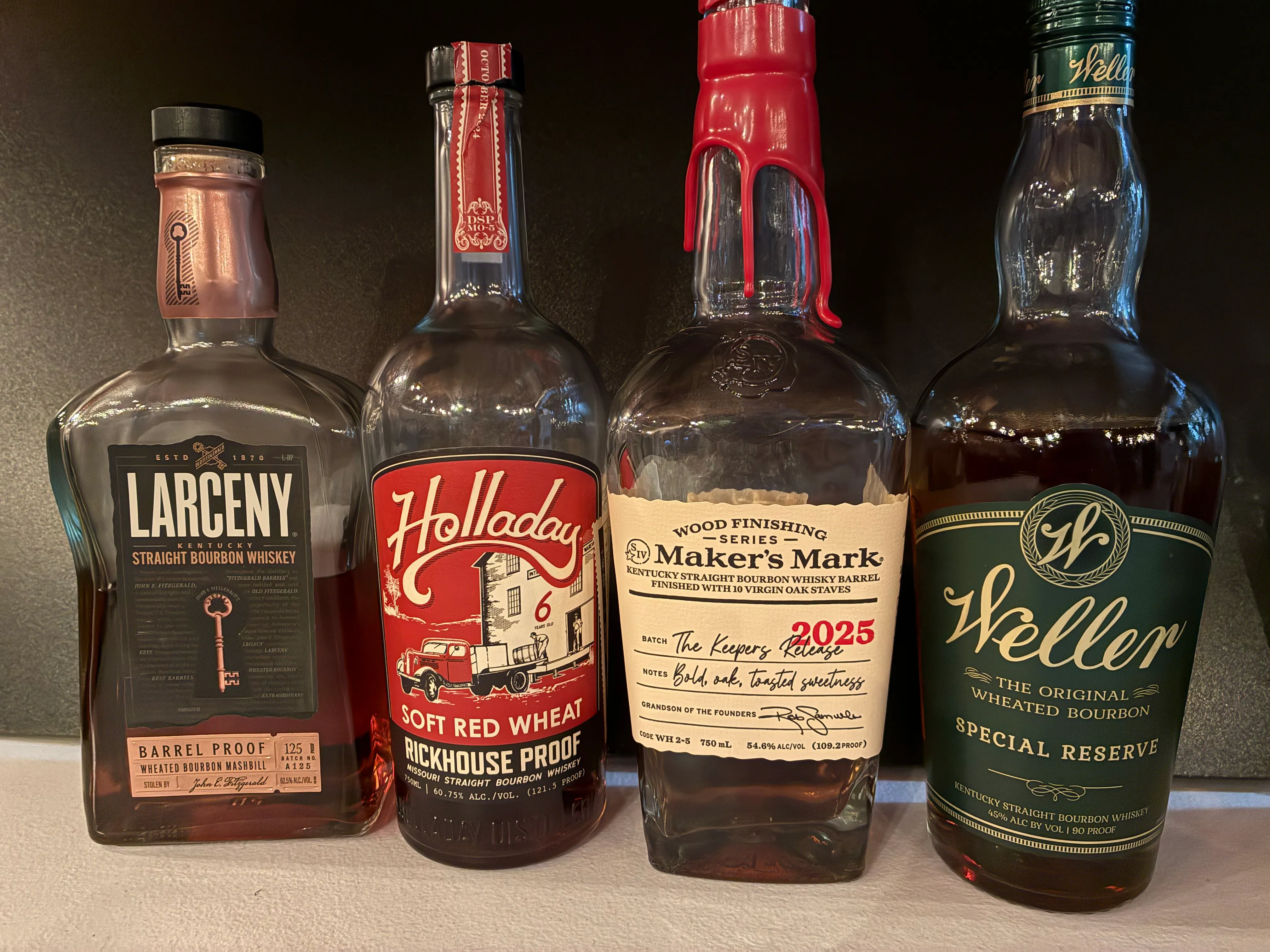 Holladay Soft Red Wheat Rickhouse Proof, Larceny Barrel Proof A125, Maker's Mark Keepers Release 2025, and Weller Special Reserve bottles